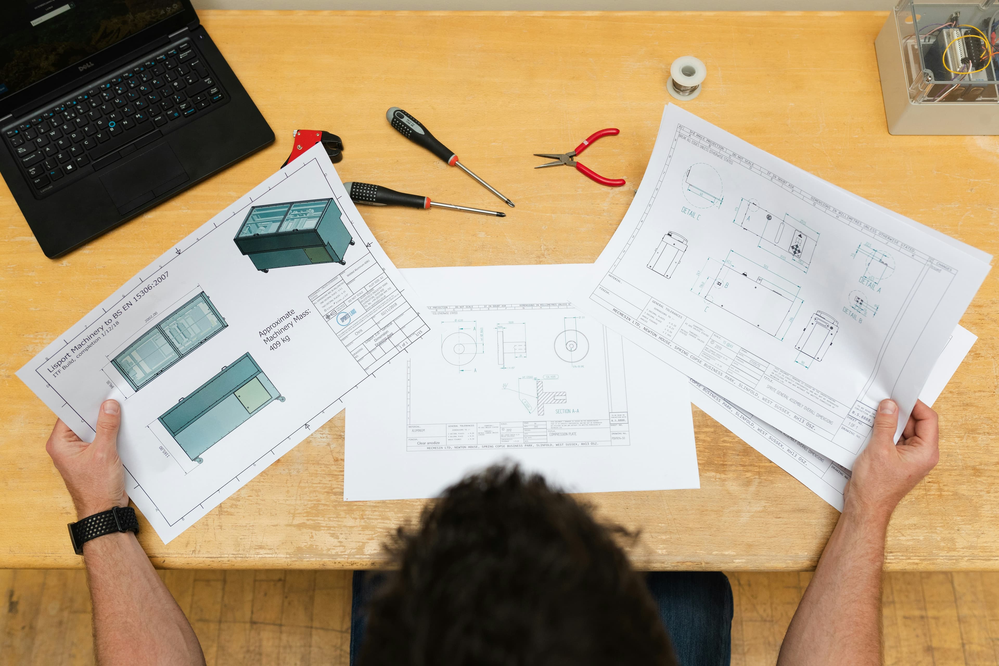 Technical drawings and tools laid out for review